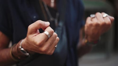 Close-up of male hands in bracelets, rings