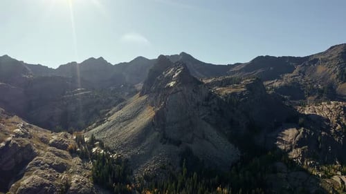 Aerial drone shot of the towering mountain peak beside Lake Blanche in Utah’s Big Cottonwood Canyon.
