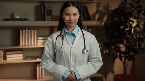 Asian Female Doctor Standing Confidently In A Medical Office During The Daytime