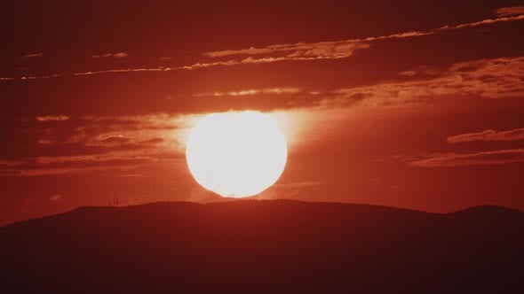 Extreme Closeup of Red Sun Rising Over a Hill Zoom Out Timelapse ...