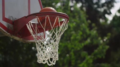 One on One Street Basketball; Closeup of Ball Going Into Basket Action