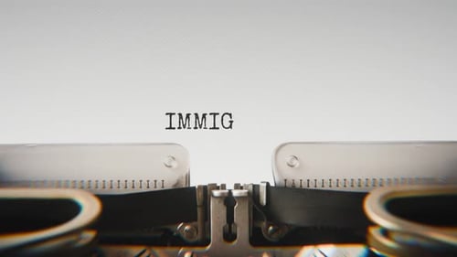 Old mechanical typewriter typing Immigration File in a close-up view.