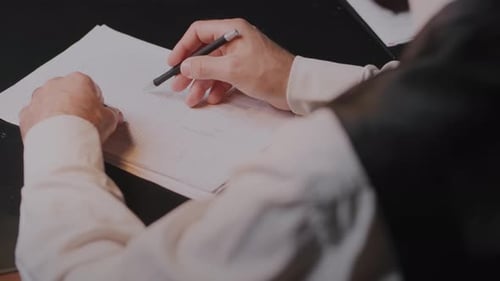 Person Circulating Text on a Document with a Pen