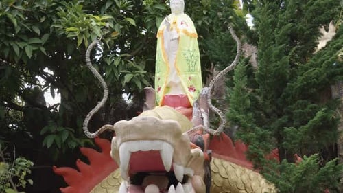 Buddha Standing On Top Of Dragon With Pearl On Its Mouth In Temple In Vietnam. - tilt up