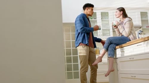 Young Couple Talking and Drinking Coffee at Home