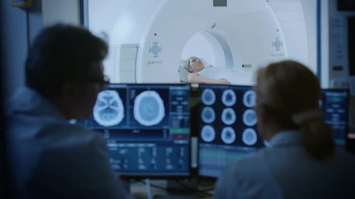 Doctors Analyzing Brain Scans of Patient in MRI
