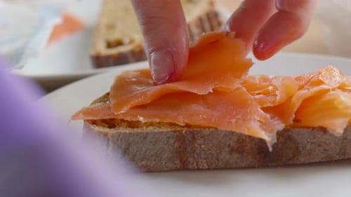 Adding Salmon to Open Faced Sandwich for Lunch