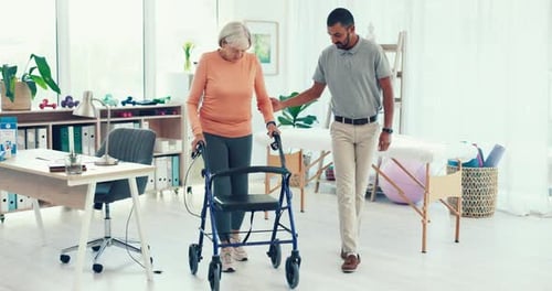 Physical Therapist Assists Senior Woman with Walker