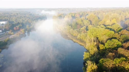 Aerial Drone View Flying Over River Calm Reflective Water Surface and White Fog