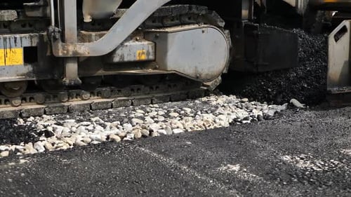 Asphalt Spreader or Asphalt Paver on a Road Construction Site Closeup