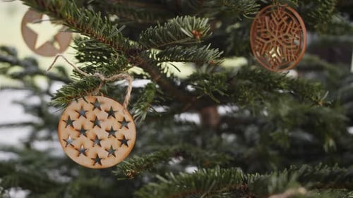 Wooden Christmas Decorations on Green Christmas Tree Handheld 4K