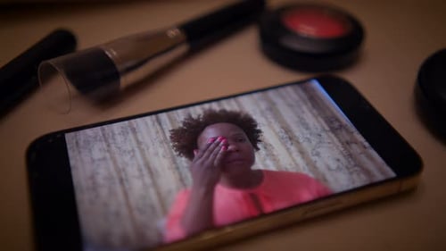 Woman Doing Makeup Online Tutorial on Phone