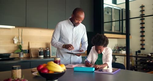 Happy dad, child and teaching with tablet for homework, school project or assignment in kitchen