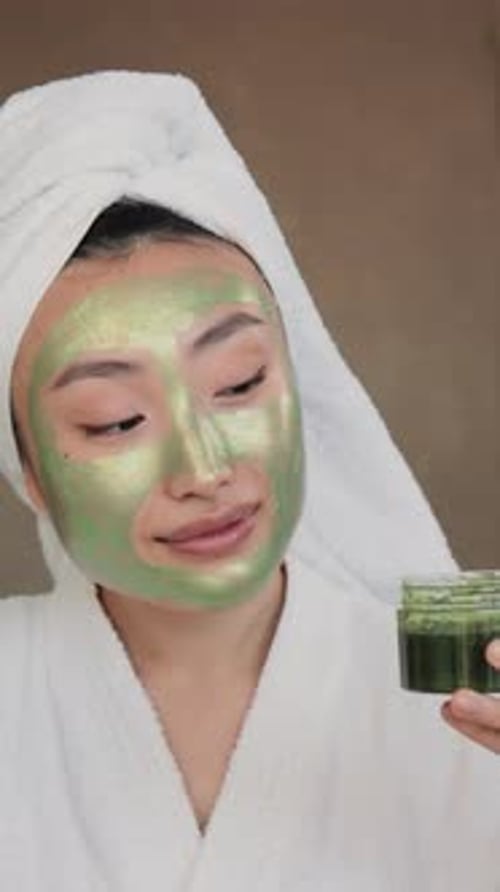 Woman Applying Green Face Mask