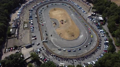 parade lap of cars before a race on a race track in the forest