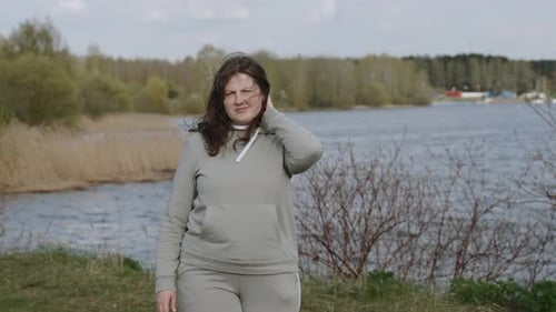 Strong Wind Blows Off Woman Curly Hair Ruining Her Hairstyle in Park