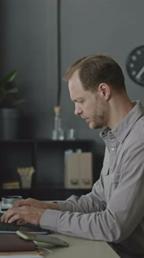 Young Businessman Using Laptop in Office