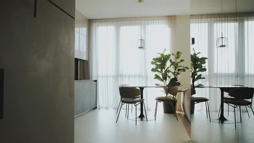 Dolly Shot of Cozy Modern Kitchen the Table and Chairs are By the Window White Tulle is on the