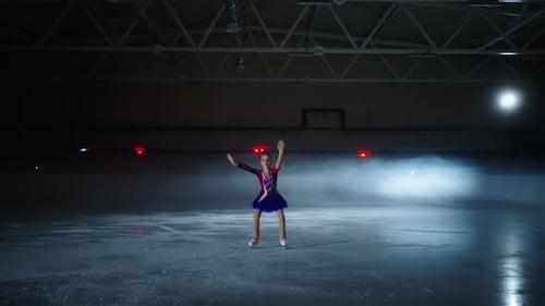 Little Girl Skating On Ice In Dark Ice Rink In Sport Arena Training Tricks And Rehearsing
