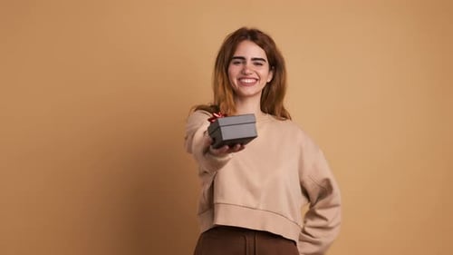 Young Woman Offers Gift Box