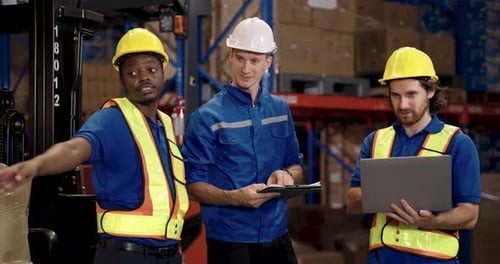 warehouse worker team including african american staff caucasian supervisor collaborating on