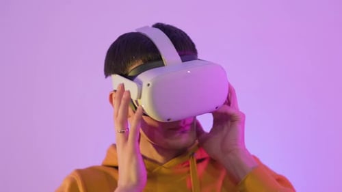 Young Adult Uses Virtual Reality Headset Indoors