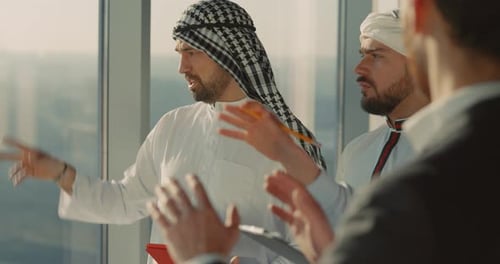 Islamic Couple of Entrepreneus Visiting Construction Company Talking to Male Executive About