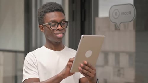 Young Adult Using Tablet in Office Setting