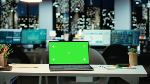 Empty Corporate Workspace with a Green Screen Laptop in a Multinational Company