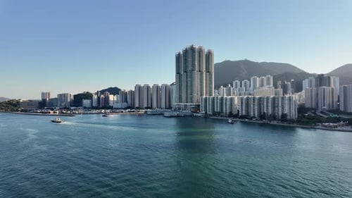 Modern skyscrapers, condos, apartments and office buildings lining the shore of urban Hong Kong. Vie