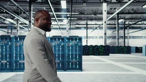 Engineer Walking in Data Center Facility Doing Inspection on Hardware Tech