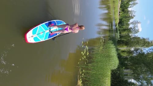 Young Woman Stand Up Paddling on Sup Board on Pond in Summer Aerial Shot