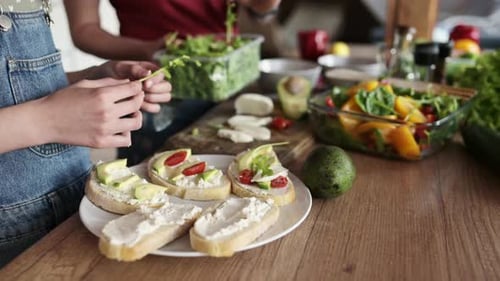 Friends Making Healthy Sandwiches Together in Kitchen