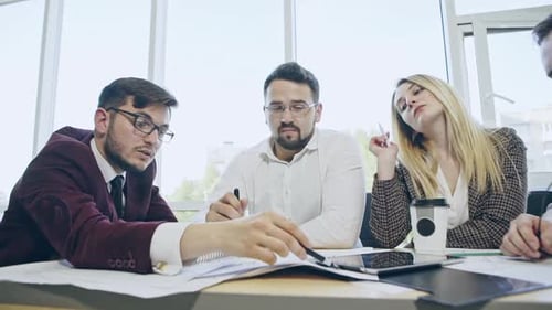 Business Team Collaborating on Project in Modern Office