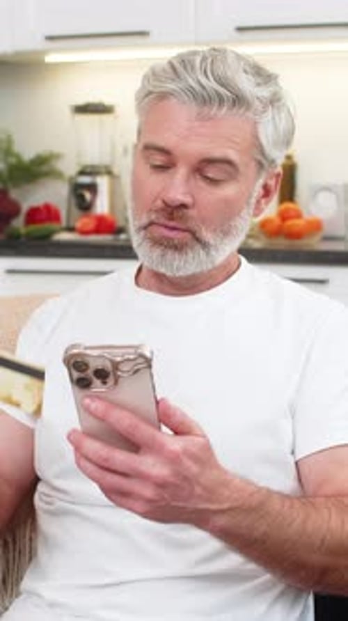 Middleaged Man Confirms Payment on Smartphone Checks Order Amount Sees Receipt Feels Satisfied