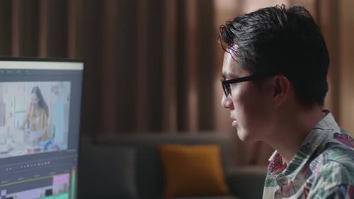 Close Up Side View Of Asian Man In Wheelchair Is Using A Desktop Editing The Video At Home