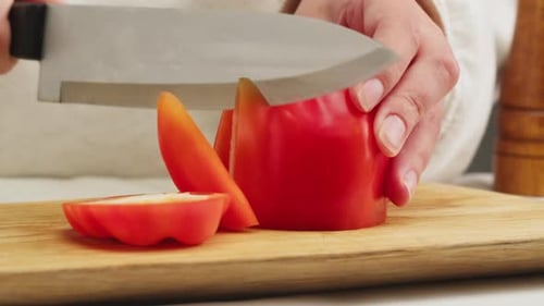 Slicing Red Bell Pepper on a Cutting Board