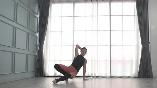 Friends practice ballet dance at studio.