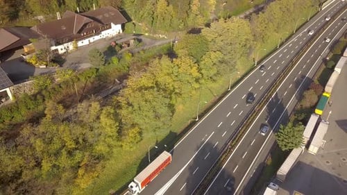Top Down Aerial View of Highway Interstate Road with Fast Moving Traffic and Parking Lot with Parked