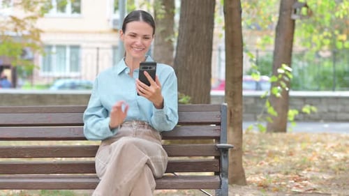 Woman on Bench Video Calling in Park
