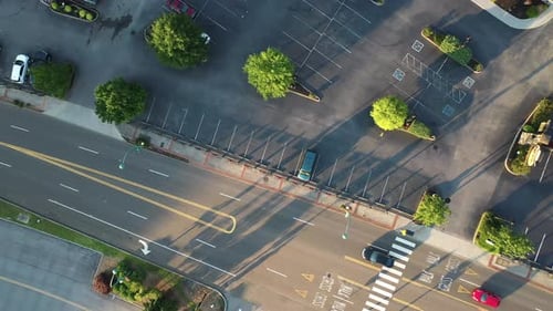 Top Down Aerial View of Street in American City and Van on Almost Empty Parking Lot. Descending High