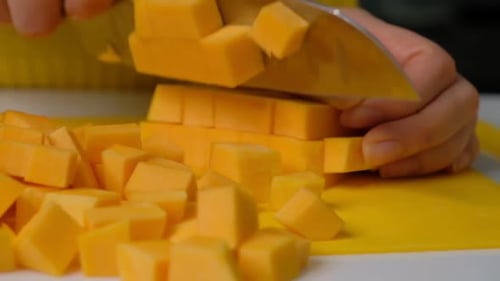 Woman Cook Cuts Pumpkin Into Small Pieces Pumpkin on a Wooden Board Ingredients for Cooking Pumpkin