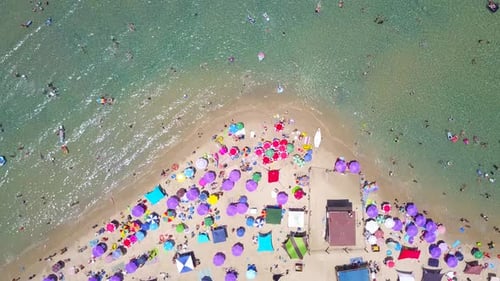 Tropical beach with colorful umbrellas - Top down aerial view