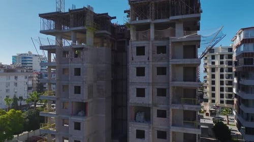 Aerial Video of a Large Construction Site in Full Operation With Heavy Machinery Cranes and Workers