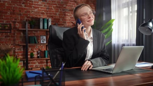 Focused Professional Talking on Phone in Modern Office