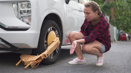 Yellow wheel clamp on an illegally parked car