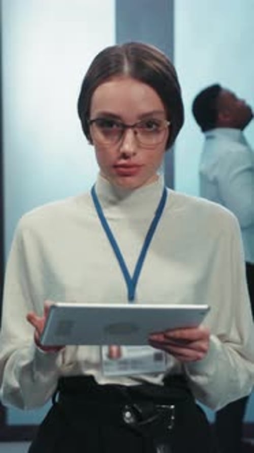 A Professional Woman is Engaged in Important Work Utilizing a Tablet in an Office Environment