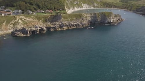 Cornwall aerial drone view of seaside rocky cliffs and turquoise water