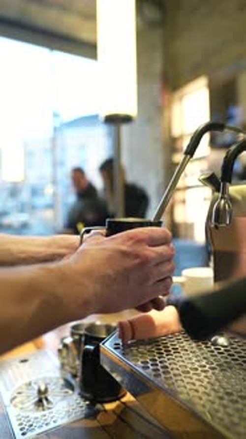 Barista Making Coffee with Espresso Machine in Urban Cafe