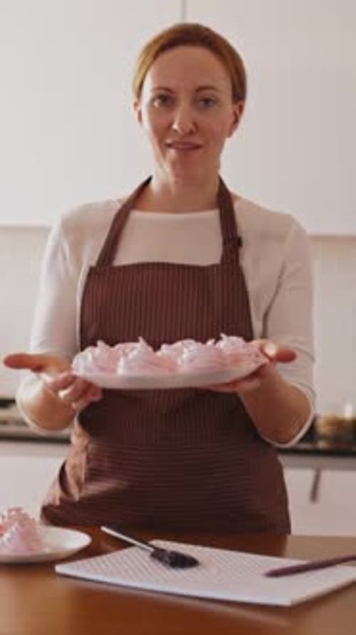 Woman Presents Pink Marshmallows in Bright Kitchen